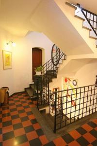 a staircase in a room with a checkered floor at Hotel Gianni Franzi in Vernazza