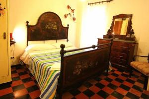 a bedroom with a large bed and a dresser at Hotel Gianni Franzi in Vernazza