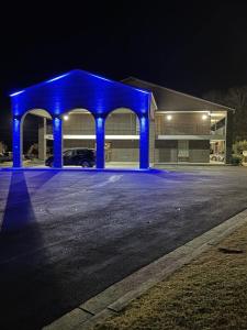 a blue building with a car garage at night at Lakeside Inn in Guntersville
