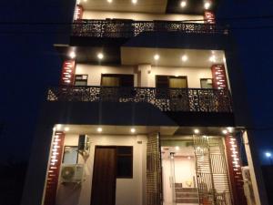 a view of a building with a balcony at night at Rukmani Inn in Vrindāvan
