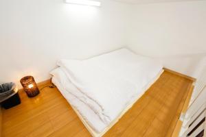 Postel nebo postele na pokoji v ubytování Tokyo Enjoy Hotel