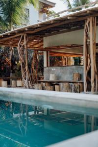 
a swimming pool with chairs and a pool table at Residencia El Balatà in Las Terrenas

