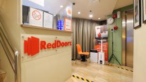 a red door store with an orange chair in a room at RedDoorz at Hotel Rosemarie in Manila