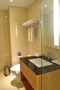 a bathroom with a sink and a toilet at Louis Kienne Hotel Simpang Lima in Semarang