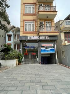 a building with a sign that reads training hotel at TITANIC HOTEL in Hanoi