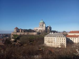 a building on top of a hill with a castle at Esztergom Central in Esztergom