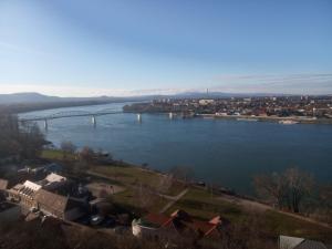 a view of a river with a bridge in the distance at Esztergom Central in Esztergom