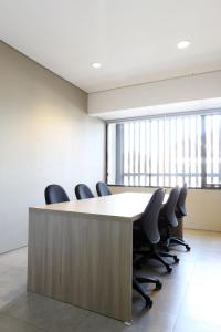 a conference room with a large table and chairs at M Suite in Tangerang