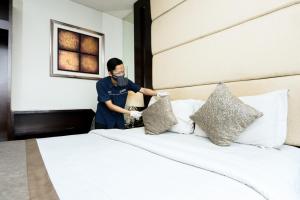 Postel nebo postele na pokoji v ubytování Serela Waringin by KAGUM Hotels