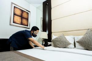 Postel nebo postele na pokoji v ubytování Serela Waringin by KAGUM Hotels