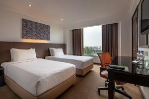 Postel nebo postele na pokoji v ubytování Bayview Hotel Georgetown Penang