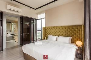a bedroom with a large bed and a large window at EXPRESSIONZ KLCC BY G Suites in Kuala Lumpur