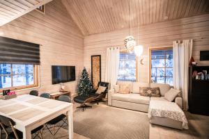 a living room with a couch and a table at Villa Lapintiira in Rovaniemi