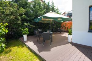 a patio with a table and an umbrella at Panorama Business Inn in Cluj-Napoca