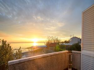 a sunset over the ocean from a house at Elegant Holiday Home in Privlakaw with Garden in Privlaka