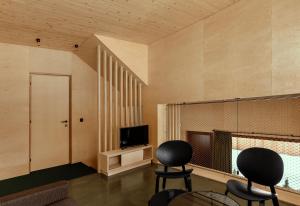 a living room with two chairs and a television at Apartment Hoamelig in Wald am Arlberg