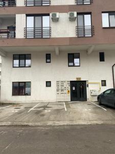 een auto geparkeerd op een parkeerplaats voor een gebouw bij Ferdinand Apartment in Constanţa