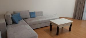 a living room with a couch and a table at Запорізька 19. City Rooms in Bila Tserkva