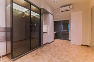 a hallway with glass doors in a building at EXPRESSIONZ KLCC BY G Suites in Kuala Lumpur
