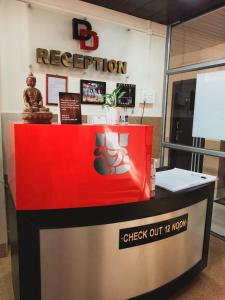 a red and black reception desk in a building at D.D Lodge in Guwahati
