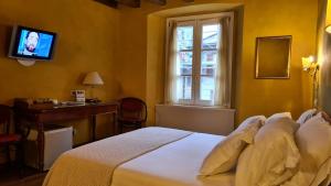 Postel nebo postele na pokoji v ubytování Hotel Piazza Vecchia