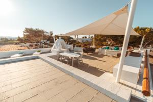 a patio with a tent and a table and chairs at Echi di Puglia Marsento in Polignano a Mare