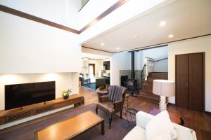 a living room with a flat screen tv and a couch at Wataya - 市原 和多屋- in Ichihara +21 photos