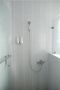 a shower with a shower head in a bathroom at Joyful Hotel in Tanjungpandan +31 photos