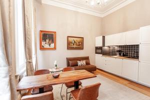 a living room with a table and a couch at Luxury Suites Palace in Antwerp