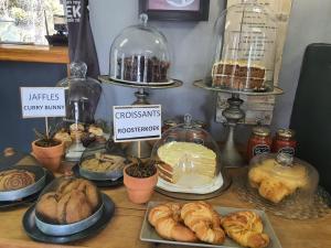 a table with different types of pastries and pies at Roche House in Queenstown