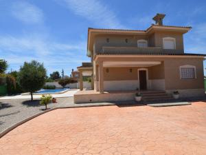 a house with a brick driveway in front of it at Superb villa for large families with large pool in San Fulgencio in La Marina