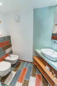 a bathroom with two toilets and a mirror at Echi di Puglia Marsento in Polignano a Mare