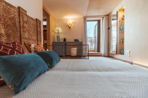 a bedroom with a large bed and a window at Echi di Puglia Marsento in Polignano a Mare