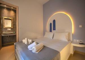 a bedroom with a bed and a bathroom with a mirror at DAFNES VILLA 1 Private Pool in Perivolos