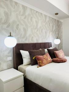 2 camas en un dormitorio con 2 luces en la pared en B&B Da Jana, en Pordenone