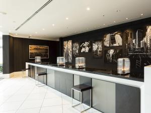 a bar in a hotel lobby with pictures on the wall at Shibuya Excel Hotel Tokyu in Tokyo +37 photos