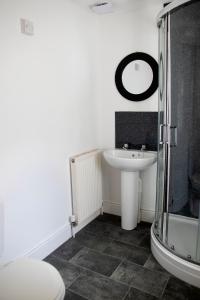 a bathroom with a sink and a toilet and a mirror at Bursar Street 19 in Cleethorpes