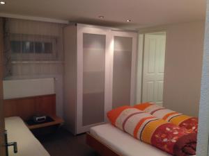 a bedroom with a bed with an orange blanket on it at Apart Susi in See