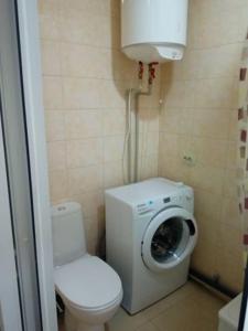 La salle de bains est pourvue de toilettes et d'un lave-linge. dans l'établissement Excellent Studio Apartaments in a Secure Residential Complex Comfort Town КТ-01, à Kiev