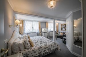 Postel nebo postele na pokoji v ubytování Hotel Belle Epoque
