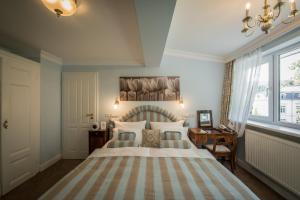 Postel nebo postele na pokoji v ubytování Hotel Belle Epoque