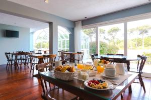 a table with fruit on it in a restaurant at Hotel Los Pinos Country in Punta del Este