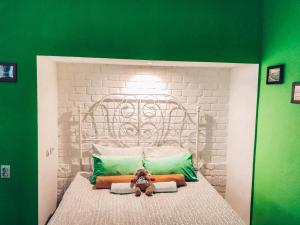 a small child sitting on a bed in a small room at Мини-отель Backpack in Kazan