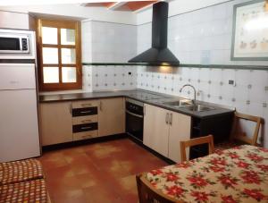 a kitchen with a sink and a stove at Casa Julián Fábrica Giner in Morella