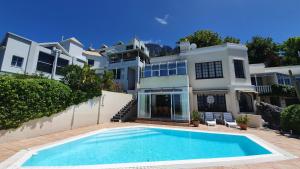 a large house with a swimming pool in front of it at Panorama Guest House in Cape Town