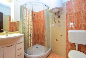 a bathroom with a shower and a toilet and a sink at Apartments Komadina 596 in Vlašići +48 photos