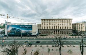 a parking lot with a large billboard in a city at Alma Apartments in Kyiv