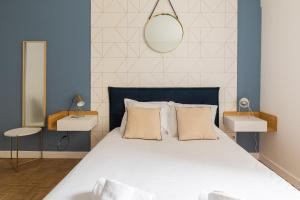 a bedroom with a bed with a blue and white wall at DIFY Charme - Bord du Rhone in Lyon