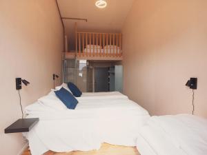 a bedroom with a bed and a desk at Preikestolen BaseCamp in Jørpeland