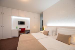 En eller flere senger på et rom på Hotel Vila Viola